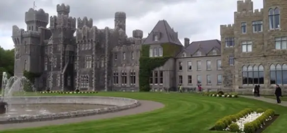 Ashford Castle in County Mayo, Ireland, with landscaped gardens and fountain, perfect for a luxury senior getaway