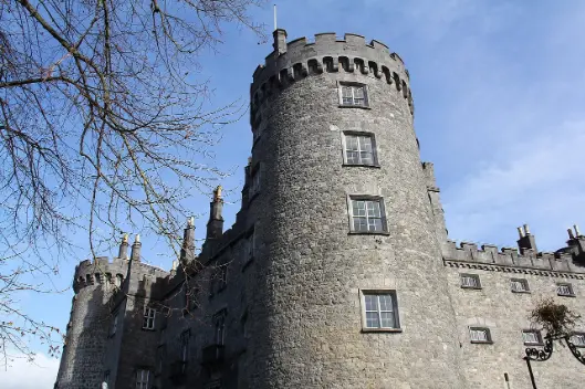 Kilkenny Castle in Ireland under a clear blue sky, a must-visit historic site for senior travelers