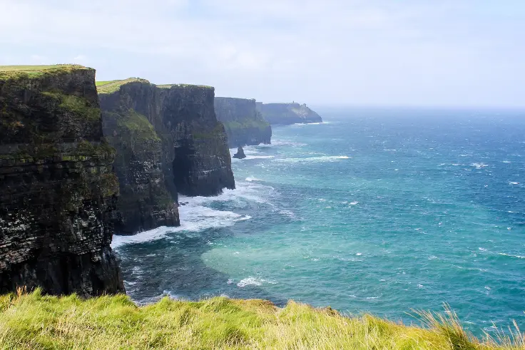 The Cliffs of Moher overlooking the Atlantic Ocean in County Clare, Ireland, a breathtaking stop for senior travelers