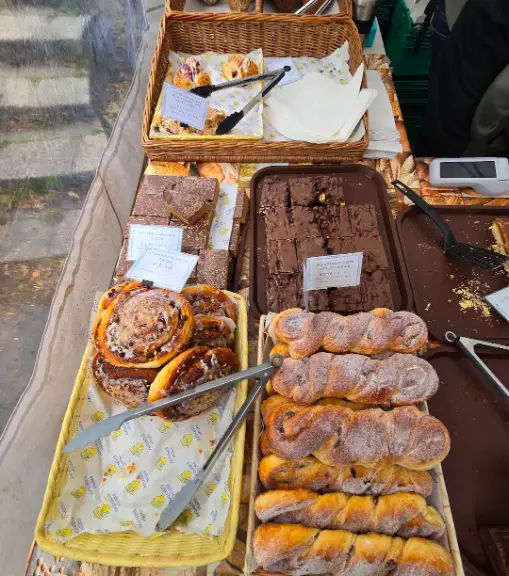 A photo featuring butter and cheese scones, rolls and croissants in Herbert Park food market.