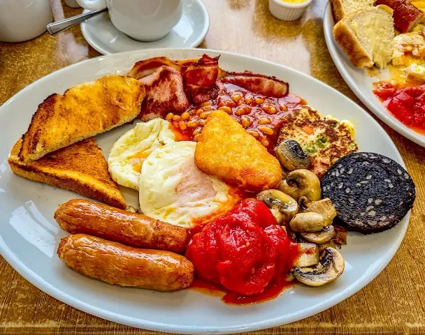 Best authentic Irish Breakfast with poached eggs, sausages, baked beans , pancakes and others in Dublin