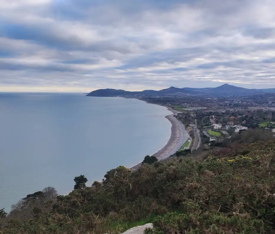 An image depicting the serene shore of Killiney Beach in Dublin.