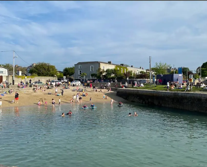 An image representing people having coastal fun in Sandycove Beach, Dublin.